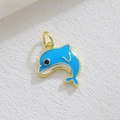 Macro view of a gold-plated dolphin pendant with blue and white enamel inlay detail - Blue White Dolphin (06)