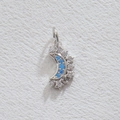 Macro shot of silver crescent moon pendant with inlaid blue diamonds and white crystals - Silver Crescent Shape (5867416729798)