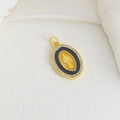 Detailed view of an oval gold-plated cross pendant with black enamel and white crystals - Black Enamel Virgin Mary Oval Style (07)