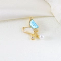 Detail of gold butterfly pendant with blue enamel, cubic zirconia and white pearl - US 10