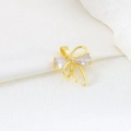 Macro shot of gold plated butterfly pendant with purple teardrop zircons on stone - EU 23