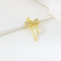 Detailed view of a gold bow pendant with zircon micro-paving and elegant metal tassels - EU 21