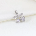 Macro detail of silver bow pendant with cherry-shaped heart cubic zirconia stones - EU 28