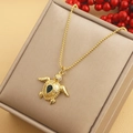 Macro shot of gold turtle pendant necklace with green teardrop stone and round bead chain - Rhinestone Turtle (04) / Gold