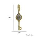 Macro detail of a 2.8cm vintage gold key pendant with zircon inlays and measurements - Vintage Key Heart Style (18)