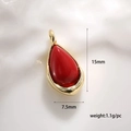 Macro detail of red teardrop stone pendant with gold edge including dimensions 15mm by 7.5mm - Natural Stone Pendant