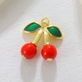 Macro shot of red cherry pendant with golden stems and green leaves for DIY jewelry - Cherry Style (01)