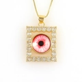 Macro view of rectangular gold pendant with micro-paved zircons and evil eye detail - Bionic Red Eye (09)