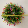 Detailed view of 34cm colorful spring flower wreath with a yellow measuring tape - Small