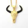 Detail of golden longhorn skull necklace with black horns and ornate floral engravings - Black Horned Bull Skull (06)