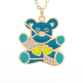 Macro shot of bear pendant necklace with turquoise enamel finish and sparkling zircons - Teal