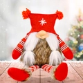Christmas gnome doll with red knitted snowflake hat and striped legs on wooden floor - Red Hat Female Style