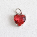 Gros plan d'un pendentif coeur en pierre rouge avec sertissage à quatre griffes argenté - Coeur Rouge à Griffes Argentées (08)