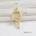 Detail view of 18k gold snake pendant with green gemstone eyes and white cubic zirconia - Gold Green Eye Snake (07)
