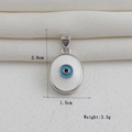 Detalle de colgante ojo de la suerte bañado en oro de 18k con medidas de 2,8 cm y 1,5 cm - Estilo Mal de Ojo Redondo de Esmalte Azul Negro Blanco Tono Plateado (14)