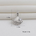 Detailed view of silver shell pendant with a clear zircon and measurement markings - Silver Single Zircon Shell (16)