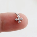 Macro detail of silver cross pendant with clear zircons held on a finger for size - Silver 5 Rhinestones (14)