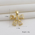 Detailed view of an 18k gold plated bow pendant with white zircon stones on white silk - Full Zircon Bow (03)