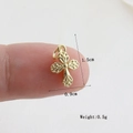 Macro shot of small gold cross charm with leaf texture measuring 1.5cm by 0.9cm - Gold Relief Pattern (19)