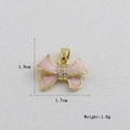 Detailed view of pink enamel bow pendant with zircon stones and dimensions 1.9x1.7cm - Pink Enamel Bow (19)