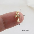 Macro shot showing small gothic cross pendant dimensions on a fingertip for scale - Gold Gothic Single Rhinestone (21)