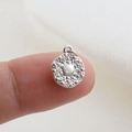 Macro shot of silver geometric star pendant with radial relief patterns and top loop - Silver Solar Pattern Style(12)