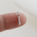 Macro shot of silver heart key pendant with sparkling cubic zirconia on fingertips - Silver Heart Key Style (14)