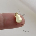 Golden gourd-shaped pendant measuring 1.4cm by 0.7cm shown for size comparison - Gold Gourd Style (15)