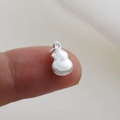 Macro view of small silver gourd pendant charm on fingertip showing scale and polish - Silver Gourd Style (16)