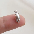 Macro view of a silver crab claw pendant held on a fingertip for size reference - Silver Crab Claw Style(18)