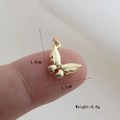 Macro detail of a 1.6cm golden butterfly pendant with purple zircon and dimensions - Gold Butterfly Style (29)