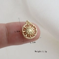 Macro view of a 1.6cm golden sun charm pendant with 1.1cm width and 1.1g weight - Gold Round Hollow Sun Ray Style (01)