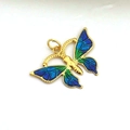 Macro detail of butterfly pendant with gold frame and blue-green enamel butterfly wings - Blue Green Gradient Spreading Wings Butterfly Style (06)