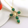 Luxurious gold cross necklace with emerald gemstones and saint medal on white silk - Emerald Style