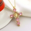 Close-up of golden cross necklace with pink stones and oval religious relief - Pink Style