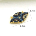 Detail showing an evil eye pendant with blue micro-zirconia in 18K gold plated copper - Gold Eye Shaped Connector (01)