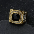 Detailed close-up of a men's gold stainless steel ring with a large black faceted gemstone - US 7 / Gold + Black Stone