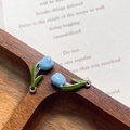 Close-up of light blue enamel tulip charms with green leaves on silver metal base - Blue Silver Ring