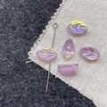 Close-up of purple leaf glass beads with aurora coating and vertical holes for DIY jewelry - Purple Leaf