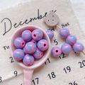 Macro view of pink and blue striped acrylic round beads for DIY jewelry making - Style 23 Pink Blue Striped 12mm