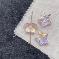 Macro detail of star-shaped aurora glass beads with colorful iridescent coating - Pink Star
