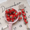 Detailed view of red circus style round beads with green star patterns for DIY jewelry - Style 20 Red Green Star Printed 12mm