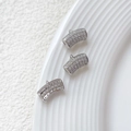 Makroansicht von drei gebogenen silbernen Anhängerröhren mit Mikro-Pave-Zirkonia-Besatz - Silber