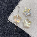 Detailed view of iridescent glass star beads for DIY handmade jewelry and craft projects - Pale Yellow Star