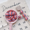 Detail of red and blue striped round beads on a ceramic spoon for DIY jewelry making - Style 17 Red Blue White Striped 12mm
