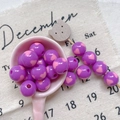 Macro shot of purple beads with pink hearts in a scoop for DIY jewelry making - Style 12 Purple Pink Heart Printed 12mm