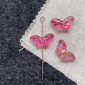 Detailed close-up of pink iridescent butterfly glass beads for DIY jewelry making - Rose Pink Butterfly