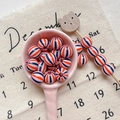 Detail of colorful striped acrylic beads in a ceramic spoon for DIY jewelry crafts - Style 6 Red Navy Striped 10mm