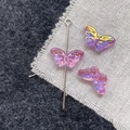 Macro shot of iridescent purple butterfly glass beads for DIY jewelry making and crafts - Pink Purple Butterfly