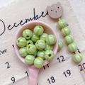 Detailed view of green and blue striped acrylic beads for DIY jewelry and phone charms - Style 2 Green Striped 10mm
